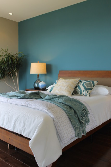 Blue Accent Wall Bedroom
 Teal Blue Wall Ikat Pillows Seeded Glass Lamps Modern