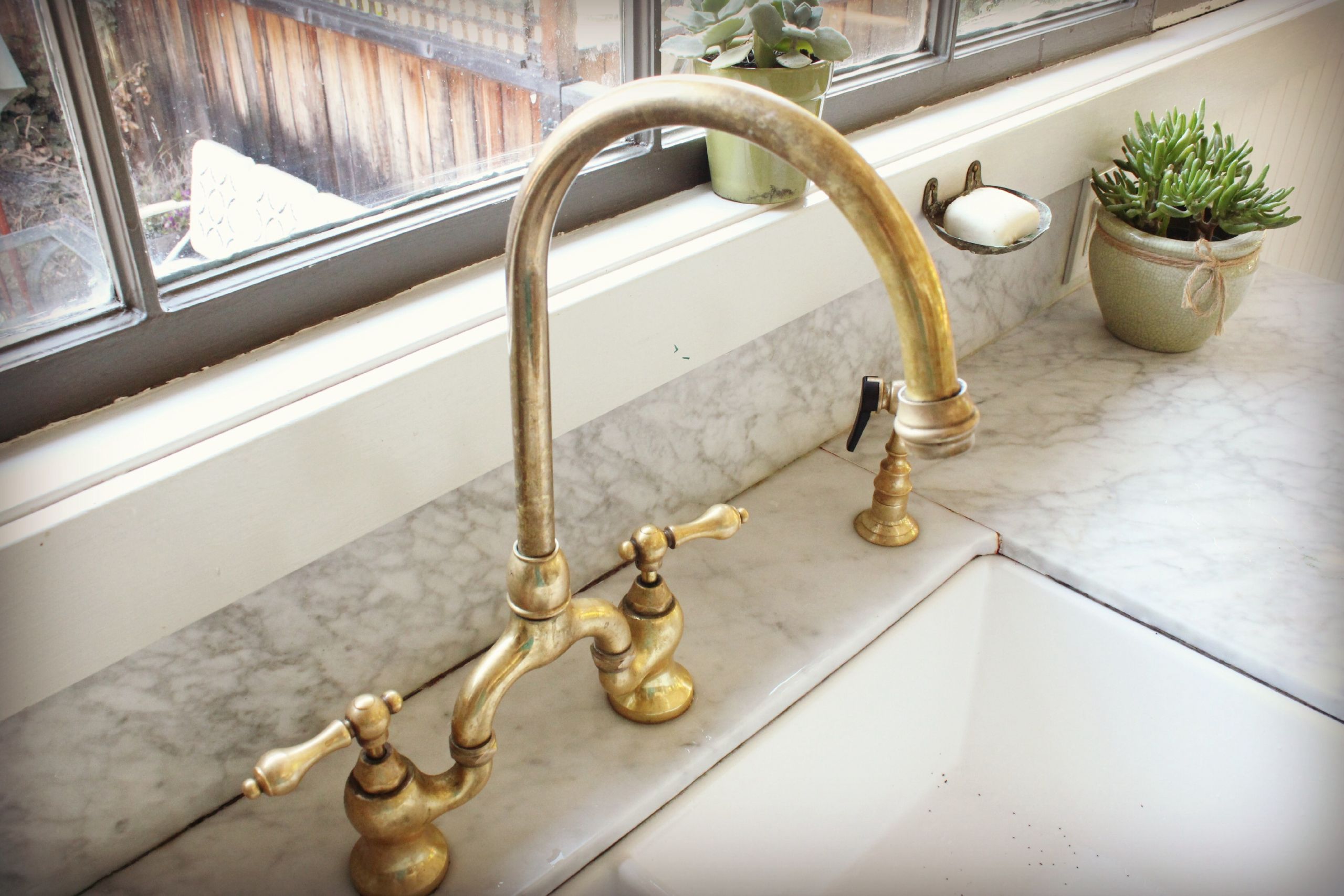 aged brass bathroom sink faucet