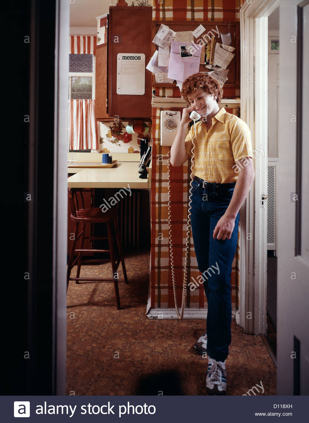 Kitchen Wall Phone
 1970s TEENAGE BOY TALKING ON KITCHEN WALL PHONE TELEPHONE